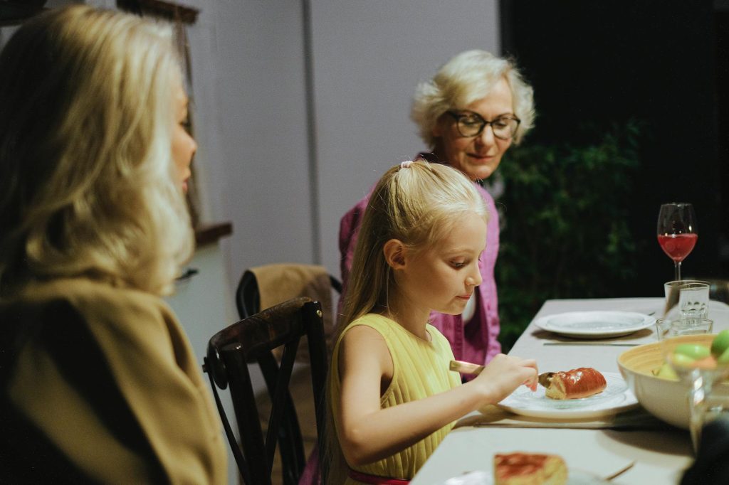 girl with grandmothers at table
