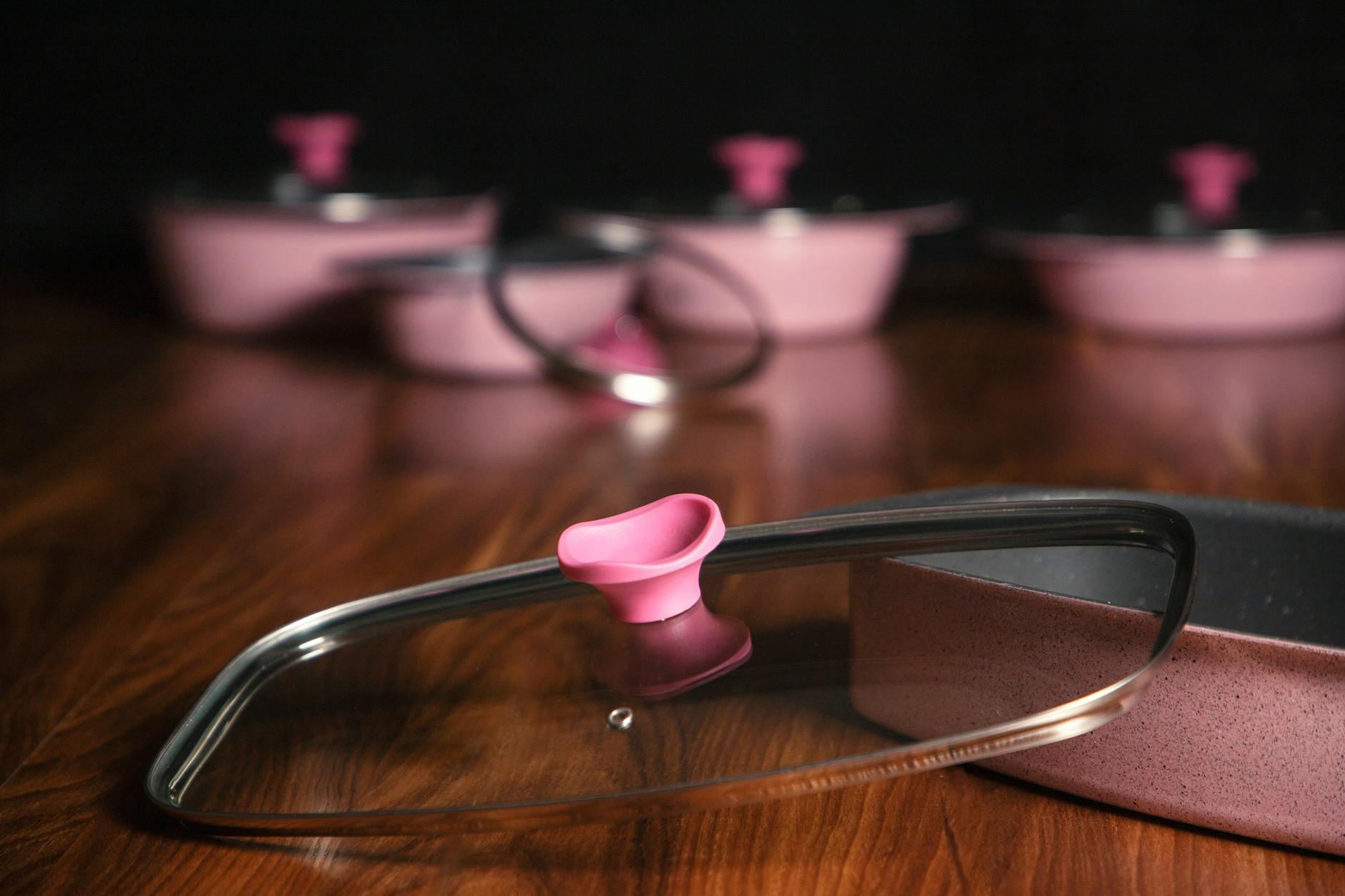 close up of pink cooking pots with glass lids
