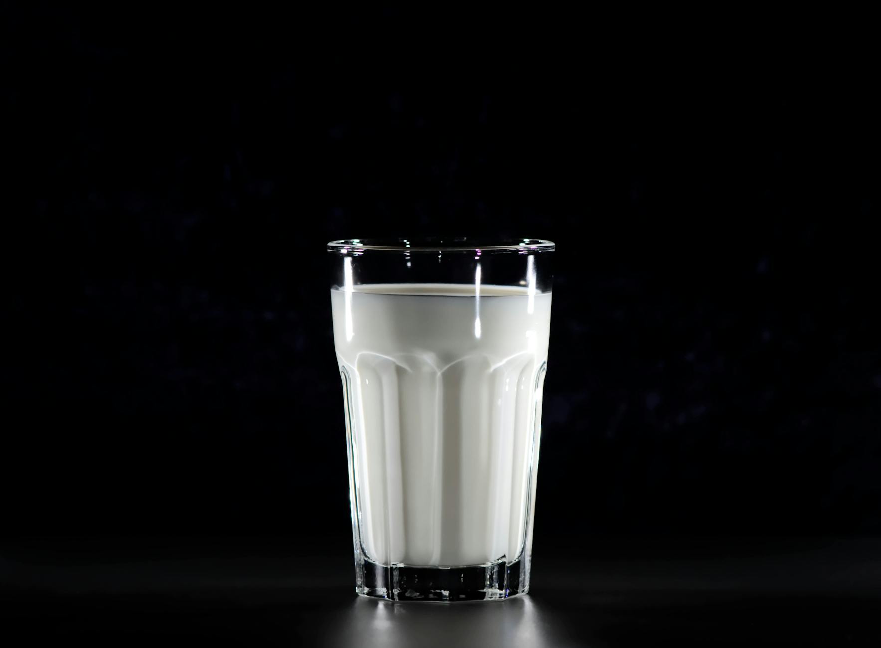 grayscale photography of glass of milk