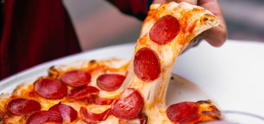 delicious pepperoni pizza slice pulled from tray