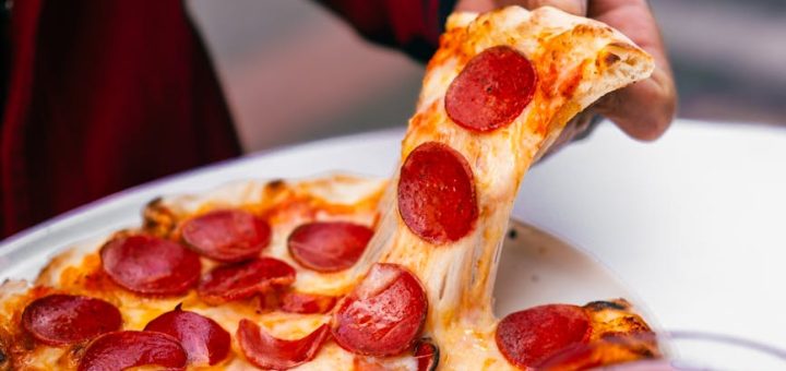 delicious pepperoni pizza slice pulled from tray