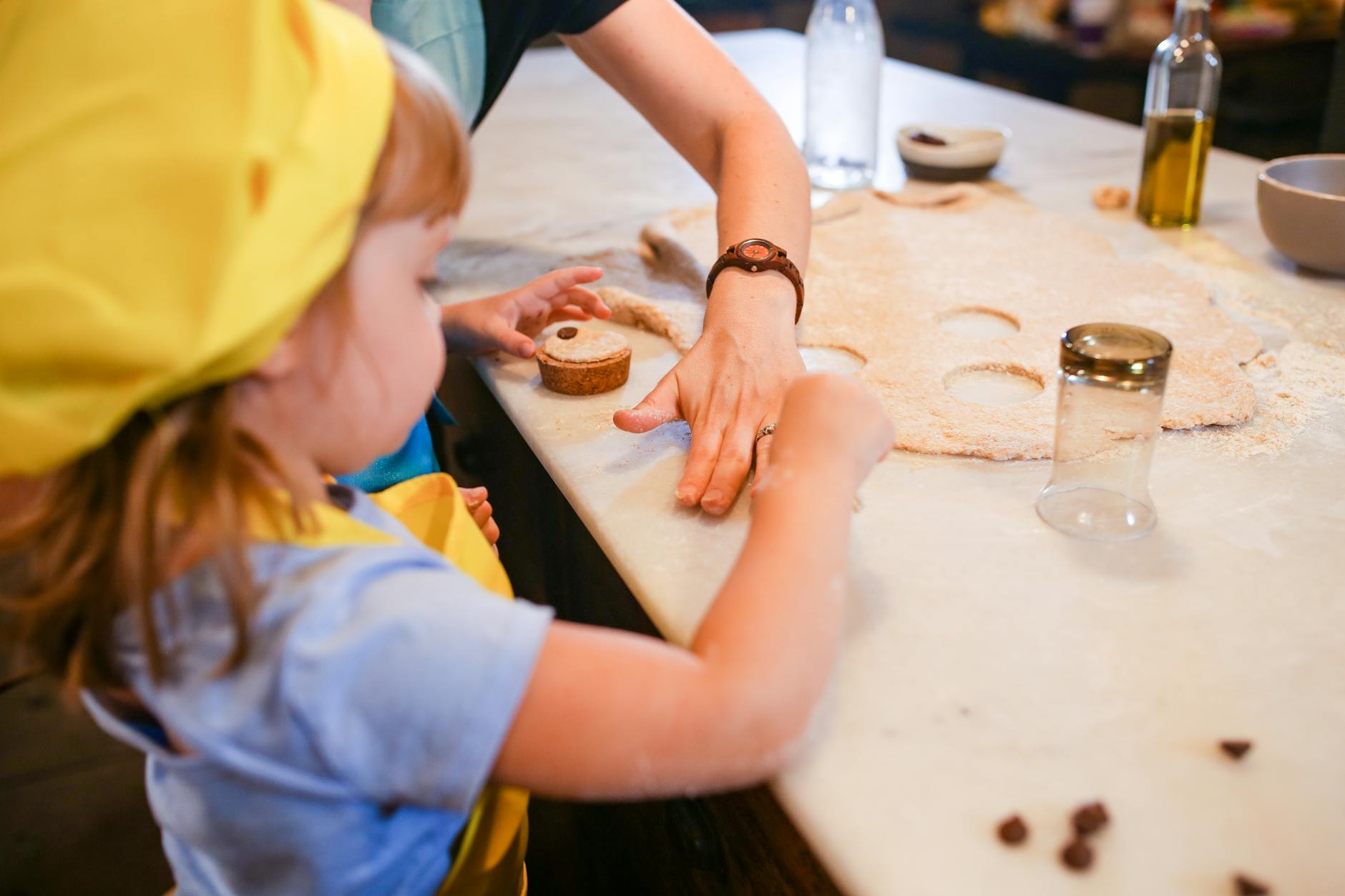 person in blue shirt slicing meat