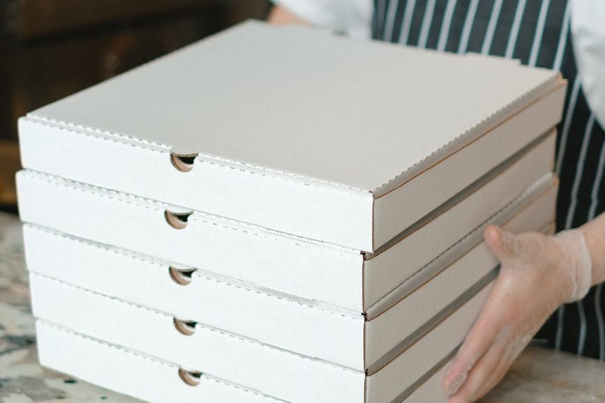 person holding white wooden box