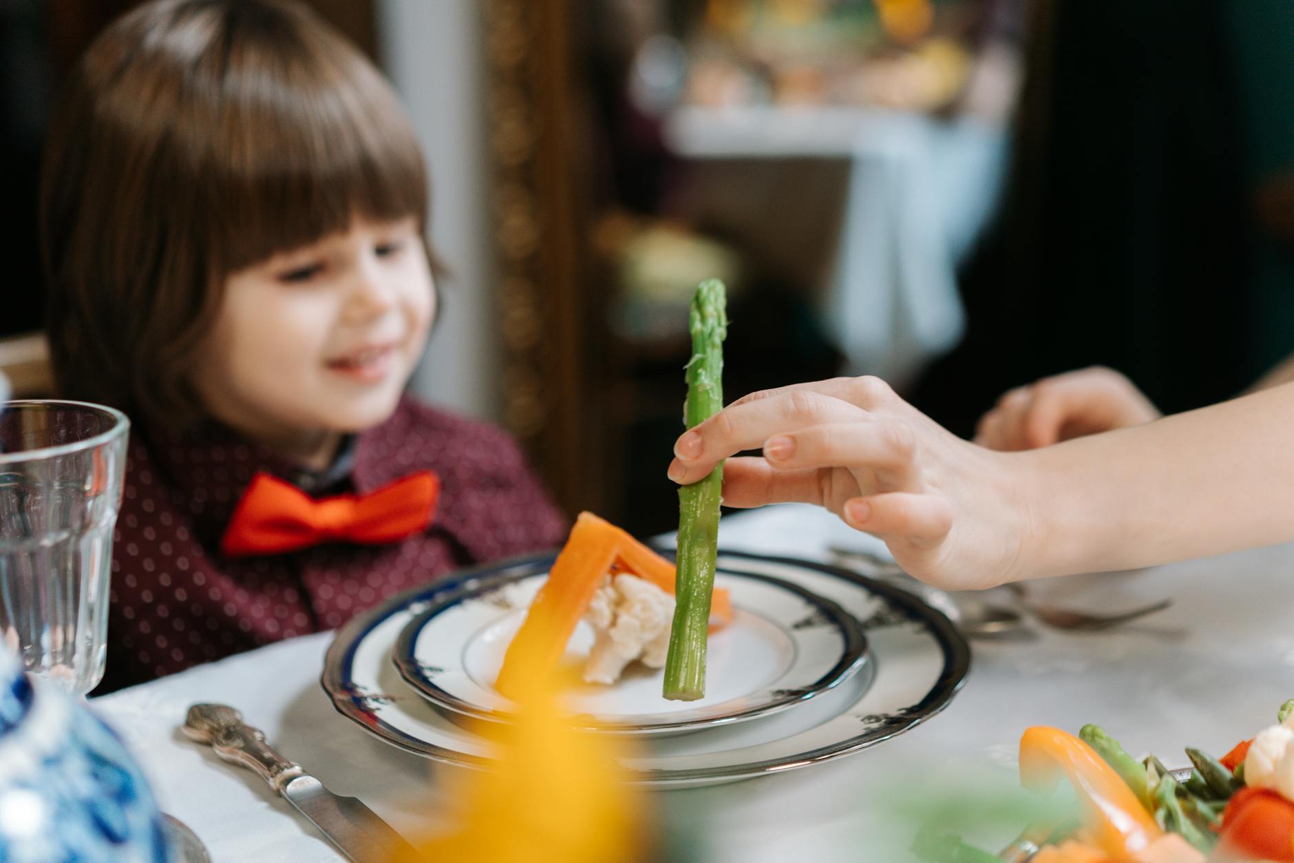 a boy eating healthy foods in a plate