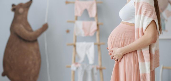 an expected mother rubbing holding her baby bump