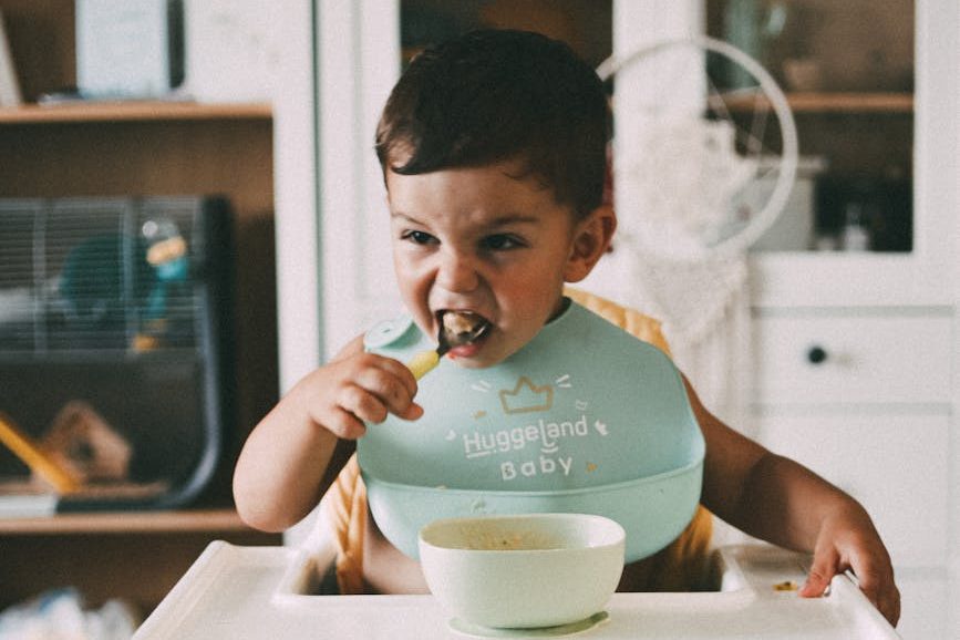 a child eating while sitting in a high chair